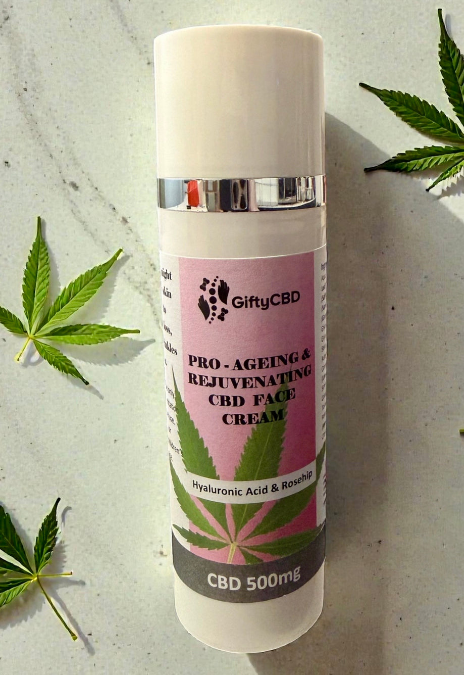CBD face cream bottle with cannabis leaves on a light background
